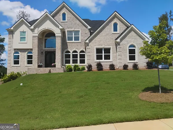 a front view of a house with a yard