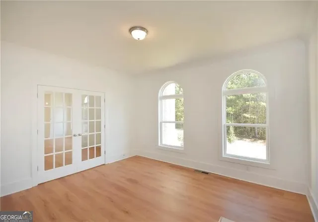 a view of an empty room with a window and fireplace