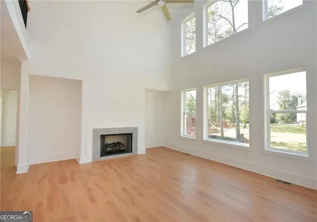 a large white kitchen with a large window a sink and a stove
