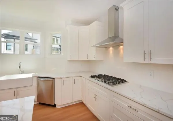 a kitchen with kitchen island white cabinets and white appliances