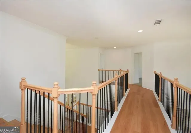a view of staircase with railing and a window