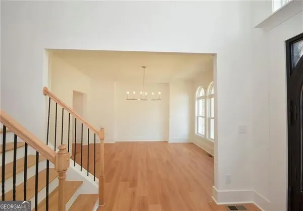 an empty room with windows and fireplace