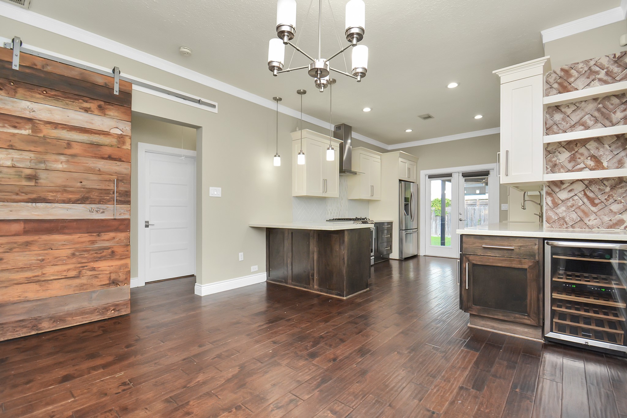 318 Ennis Street Houston, TX 77003 - Photo 6 of 28 Heigh ceilings, recessed lighting, exposed brick with dry bar and mini wine fridge.
