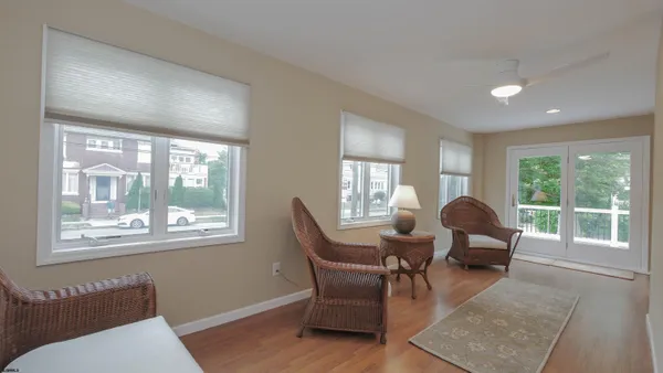 a living room with furniture and floor to ceiling windows