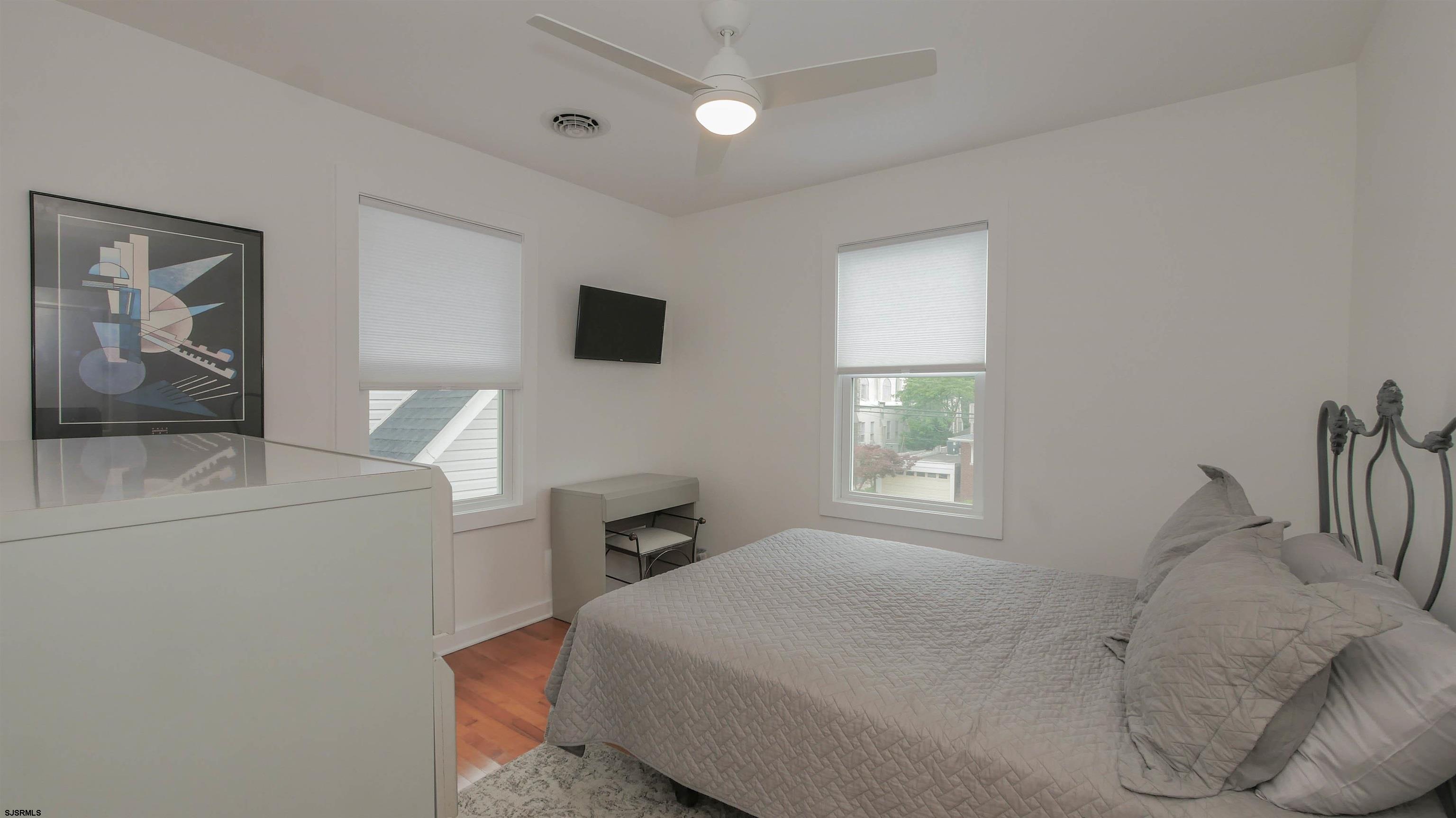 1 North Surrey Avenue, Unit CUSTOMIZE RENTAL Ventnor City, NJ 08406 - Photo 19 of 36 a bedroom with a bed and a tv