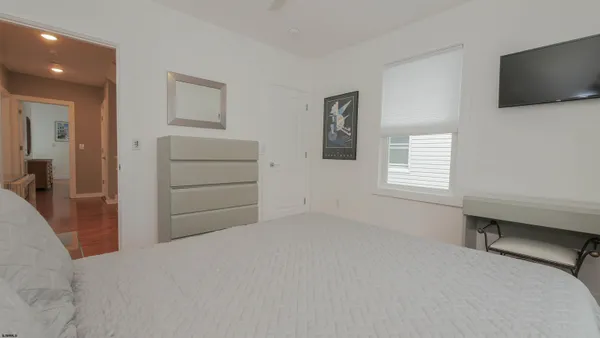 a room with a bed and a television