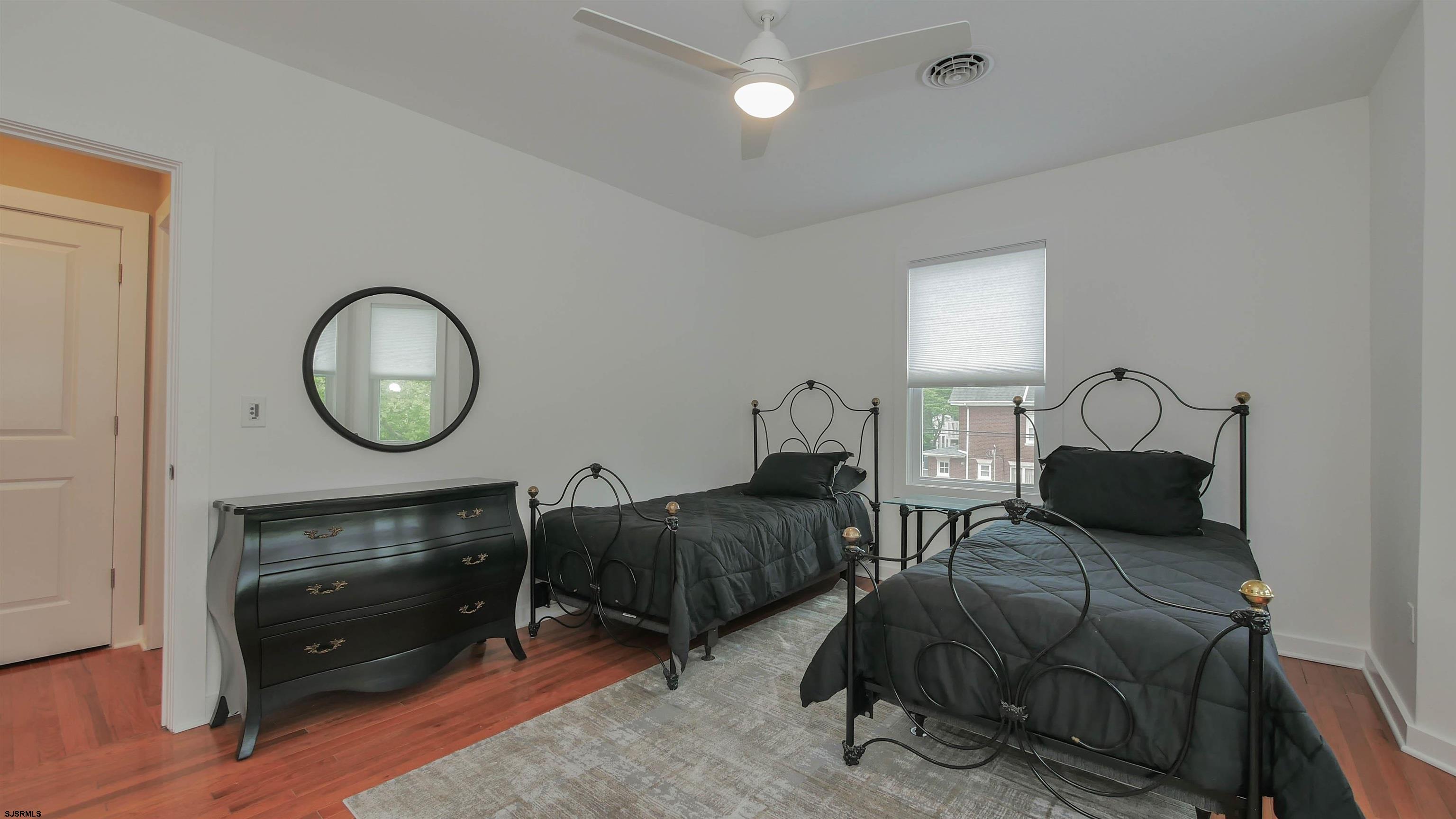 1 North Surrey Avenue, Unit CUSTOMIZE RENTAL Ventnor City, NJ 08406 - Photo 22 of 36 a bedroom with bed and a mirror