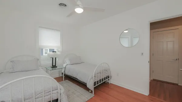 a bedroom with a bed and a night stand