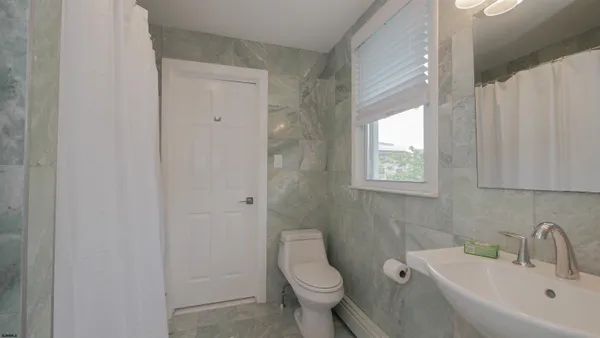a white toilet sitting next to a bathroom sink
