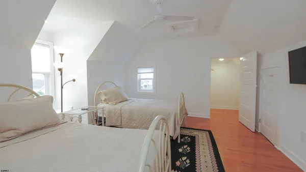 a bed room with a bed window and a television