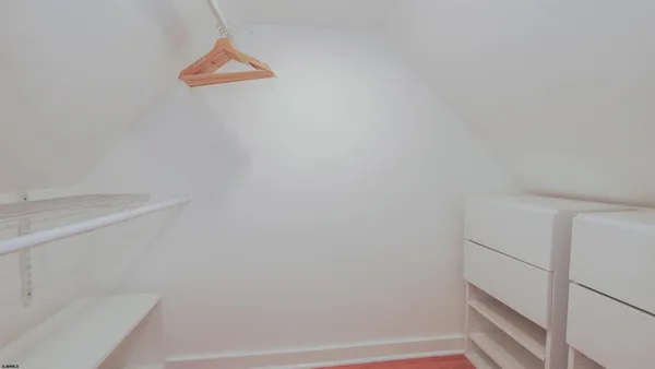 a bedroom with bed and a night stand