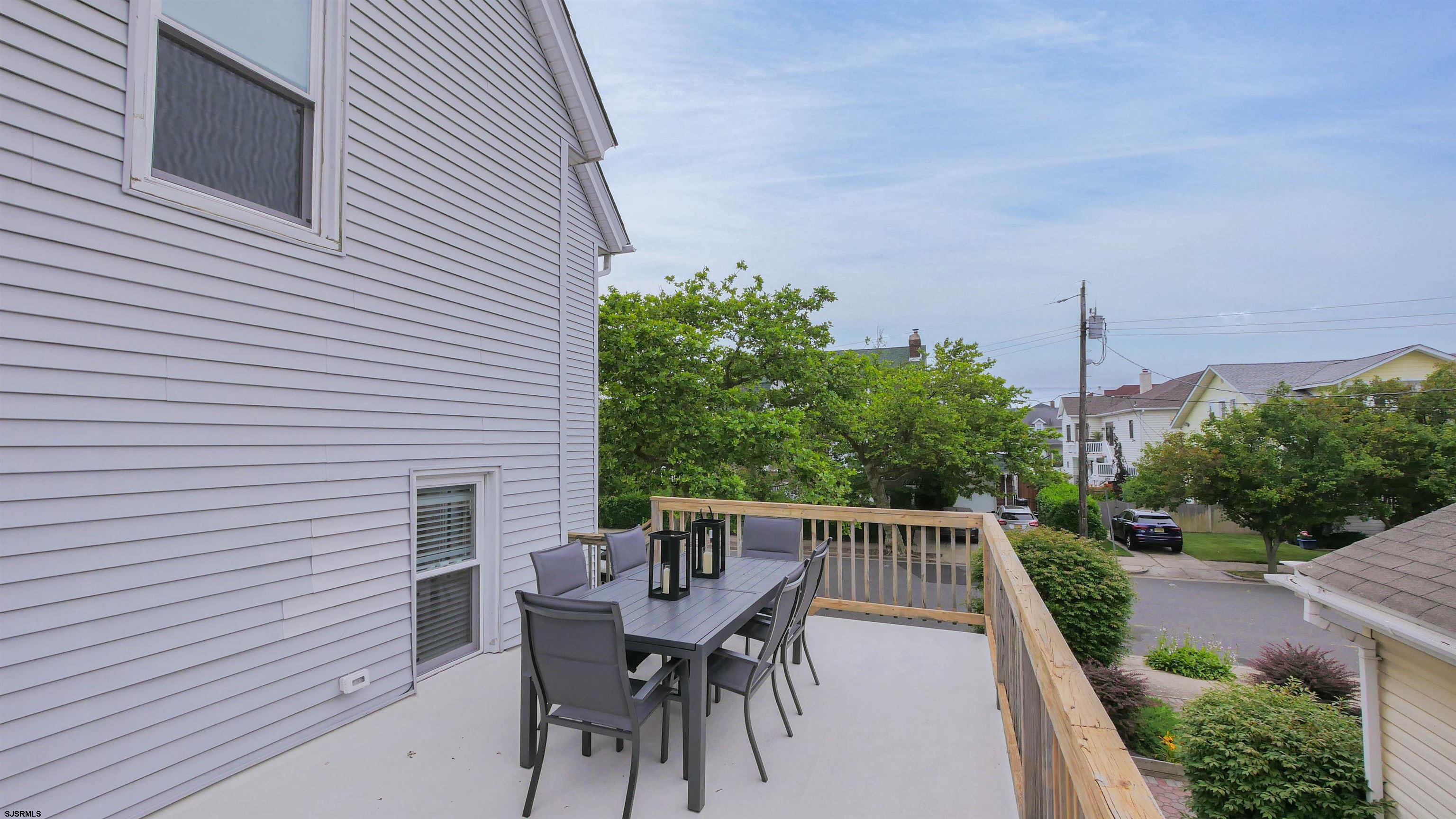 1 North Surrey Avenue, Unit CUSTOMIZE RENTAL Ventnor City, NJ 08406 - Photo 36 of 36 a balcony with table and chairs and potted plants