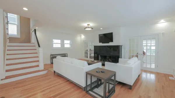 a living room with furniture wooden floor and a fireplace