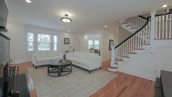 a living room with furniture and a wooden floor