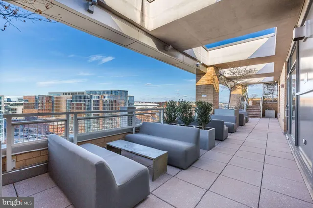 a balcony with furniture and a view of city