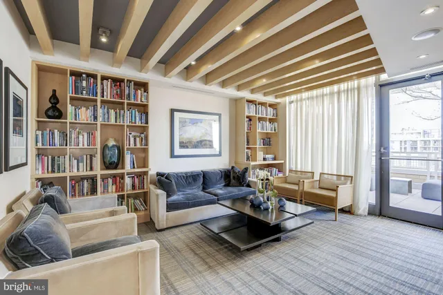 a living room with furniture and a book shelf