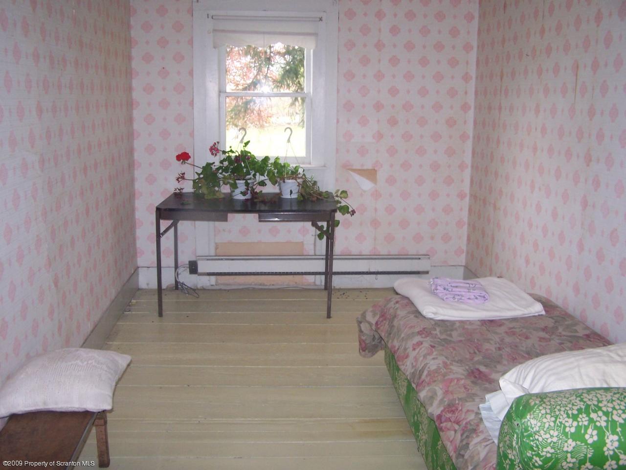 407 Gravity Road Lake Ariel, PA 18436 - Photo 16 of 27 a bed room with a bed and a chair