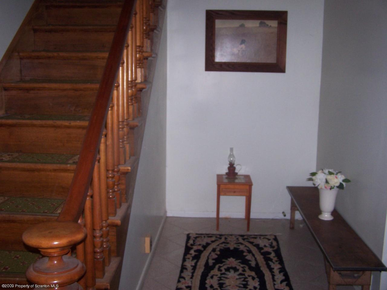 407 Gravity Road Lake Ariel, PA 18436 - Photo 17 of 27 a bedroom with a bed and a chair