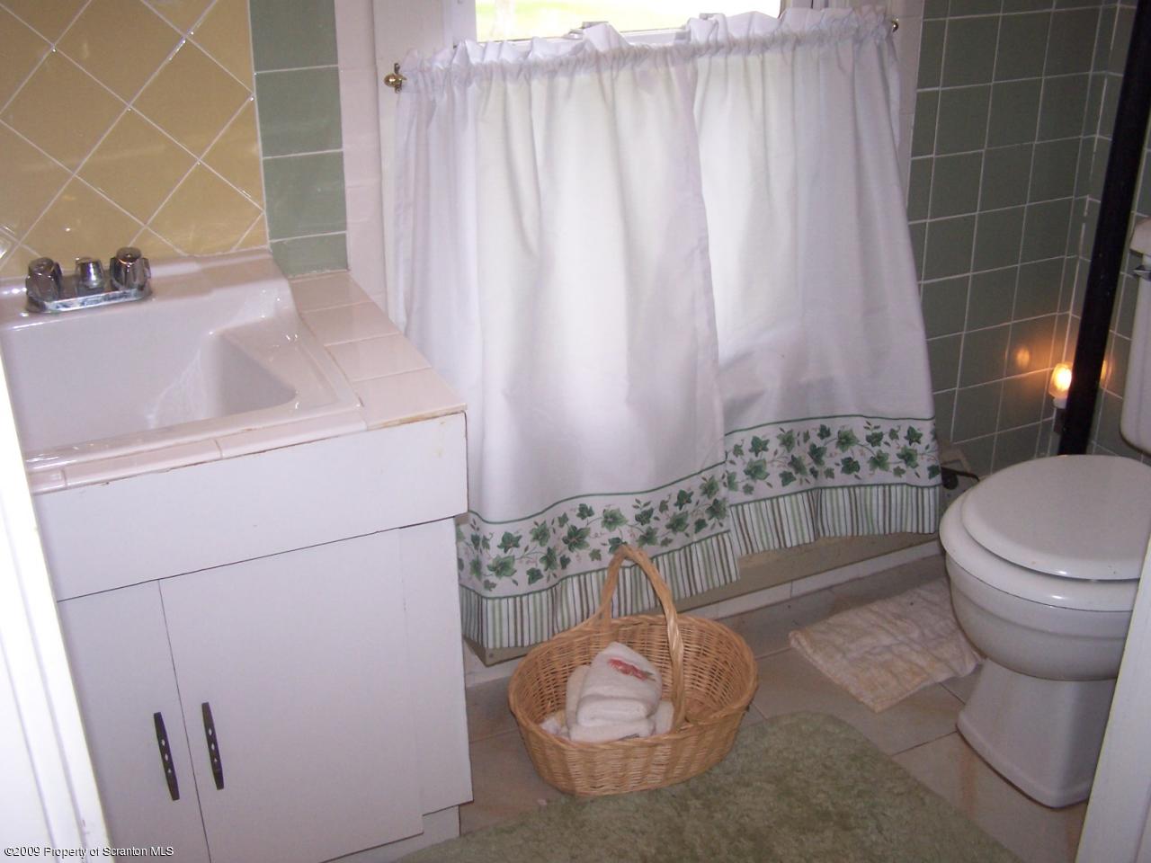 407 Gravity Road Lake Ariel, PA 18436 - Photo 4 of 27 a bathroom with a sink toilet and shower