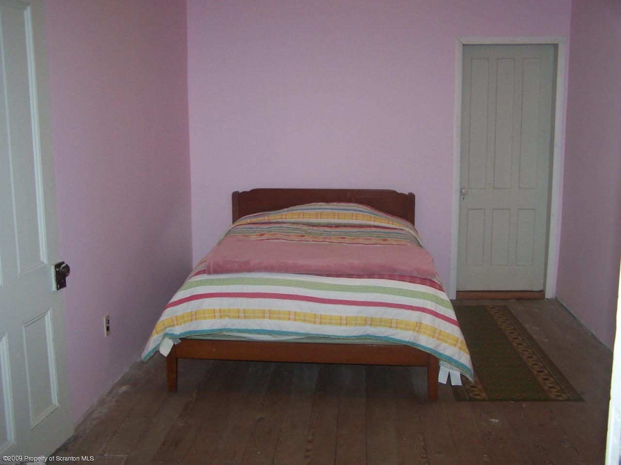 407 Gravity Road Lake Ariel, PA 18436 - Photo 6 of 27 a bedroom with a bed and a dresser