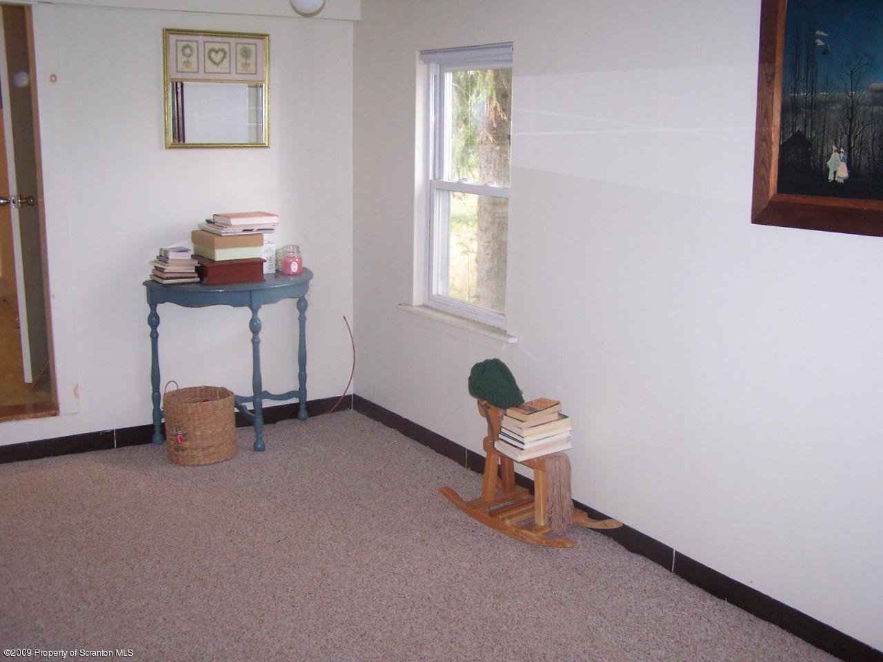 407 Gravity Road Lake Ariel, PA 18436 - Photo 9 of 27 a room with gym equipment and a window
