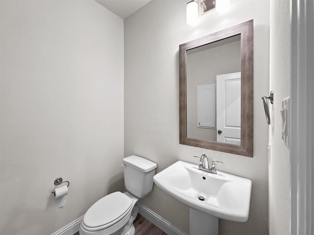 8876 Samara Street Frisco, TX 75035 - Photo 12 of 28 a bathroom with a sink a toilet and mirror