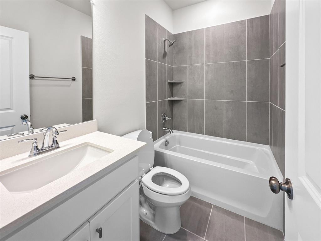 8876 Samara Street Frisco, TX 75035 - Photo 21 of 28 a bathroom with a sink a toilet and a bathtub
