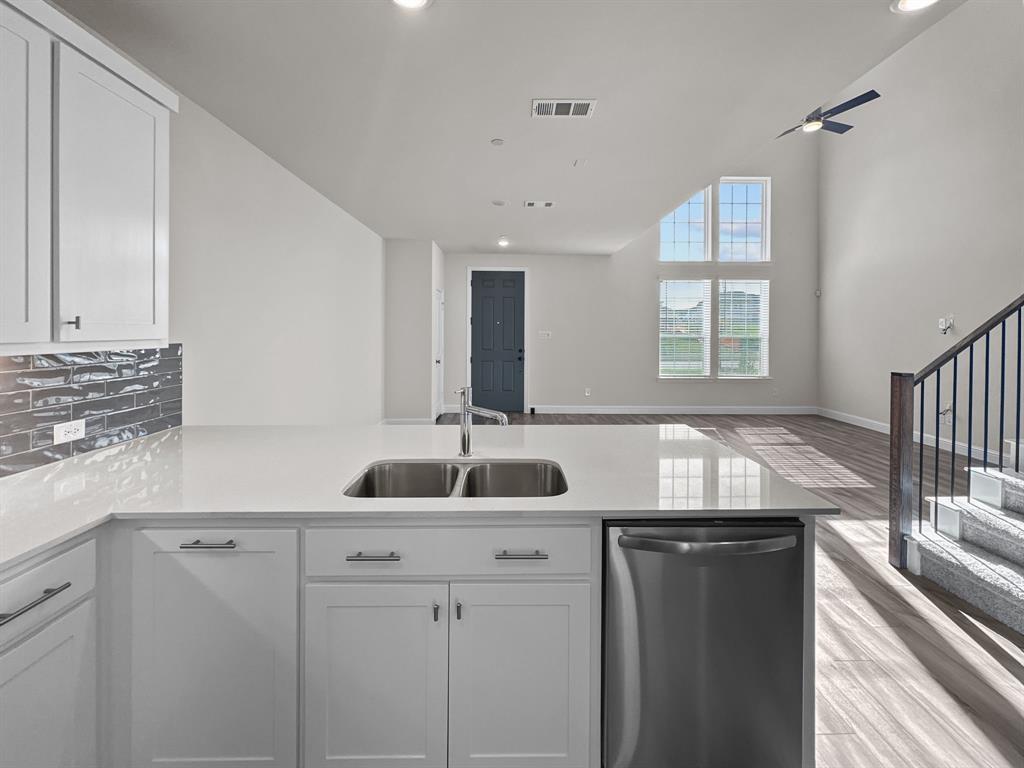 8876 Samara Street Frisco, TX 75035 - Photo 9 of 28 a kitchen with granite countertop kitchen island a sink and a window