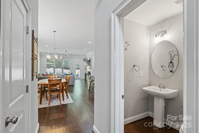 a kitchen with granite countertop a sink appliances and chairs