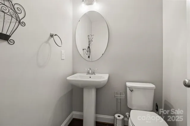a kitchen with granite countertop a stove and white cabinets