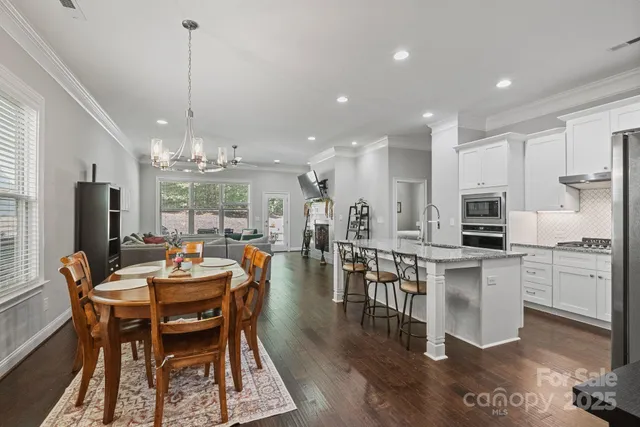 a kitchen with center island table and chairs