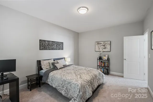 a bathroom with a sink a toilet a mirror and shower curtain