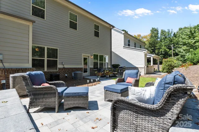 a view of a patio with couches chairs and a fire pit