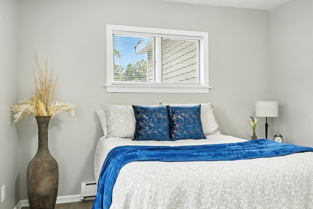 77 Coleman Street Springfield, MA 01109 - Photo 13 of 24 a bed sitting in a bedroom next to a window