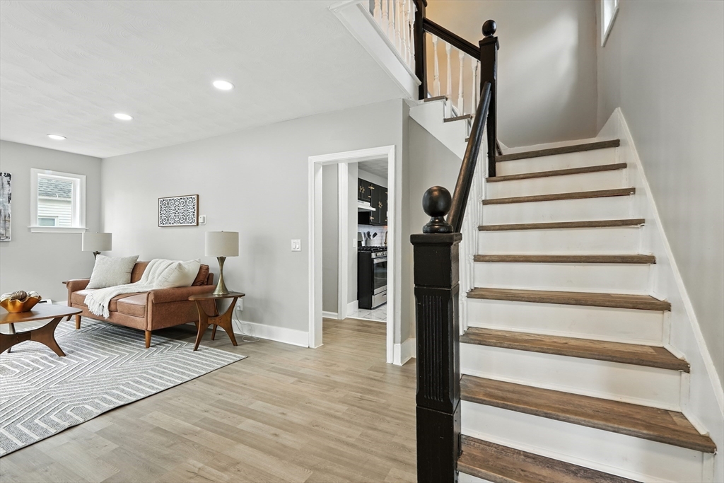 77 Coleman Street Springfield, MA 01109 - Photo 15 of 24 a living room with furniture and a stair