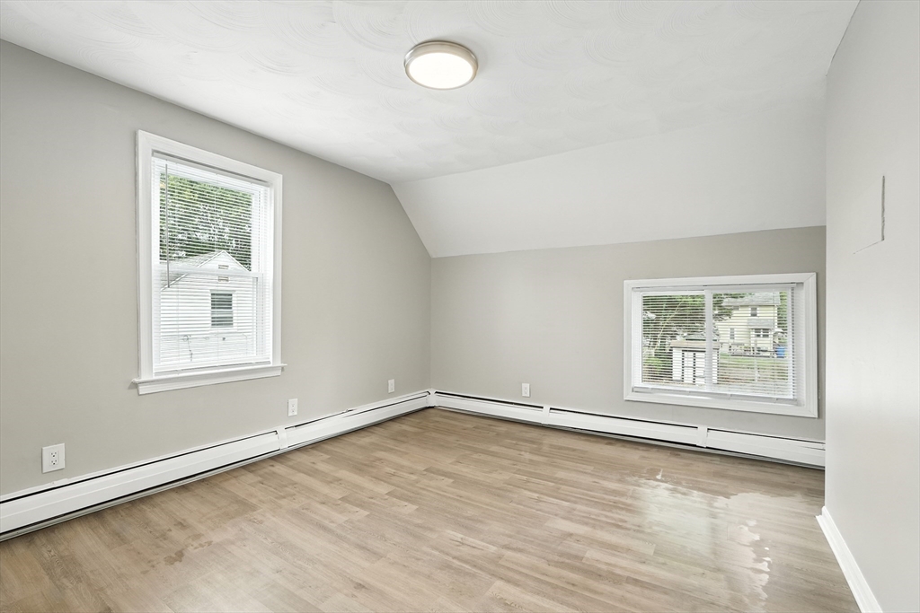 77 Coleman Street Springfield, MA 01109 - Photo 18 of 24 an empty room with wooden floor and windows