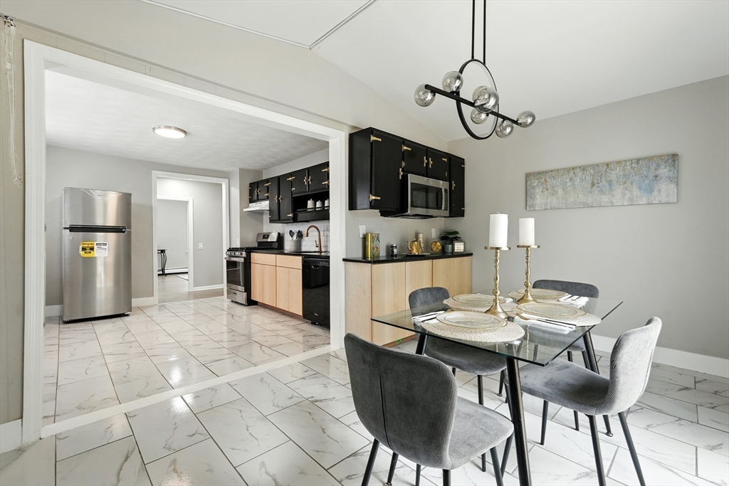 77 Coleman Street Springfield, MA 01109 - Photo 10 of 24 a view of a dining room with furniture and a kitchen