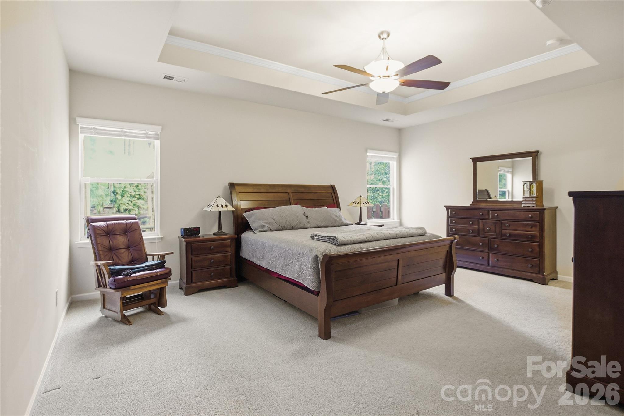 11824 Springpoint Lane Charlotte, NC 28278 - Photo 13 of 26 a spacious bedroom with a bed and a couch