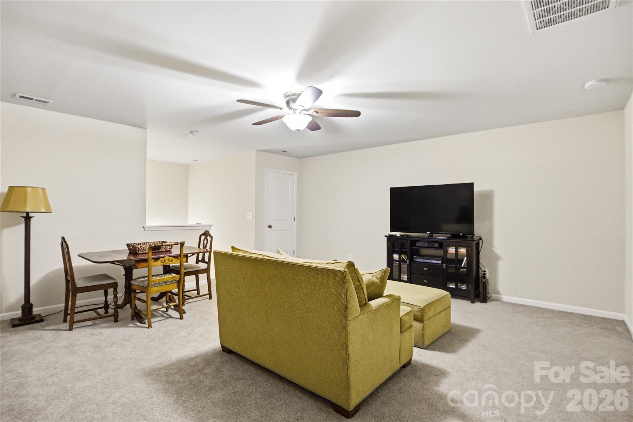 11824 Springpoint Lane Charlotte, NC 28278 - Photo 17 of 26 a living room with furniture and a flat screen tv