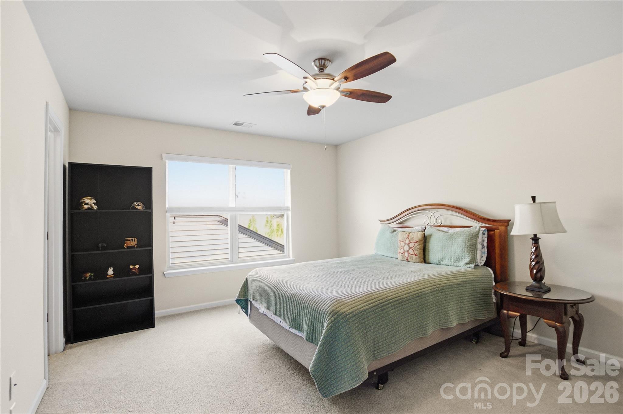 11824 Springpoint Lane Charlotte, NC 28278 - Photo 20 of 26 a bedroom with a bed and window