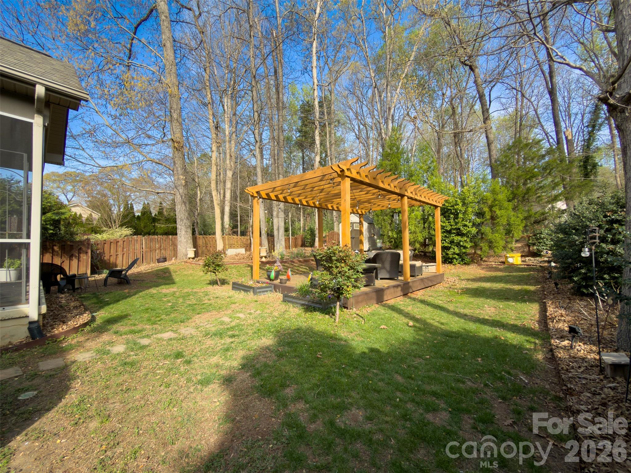 11824 Springpoint Lane Charlotte, NC 28278 - Photo 24 of 26 a view of a house with backyard porch and sitting area