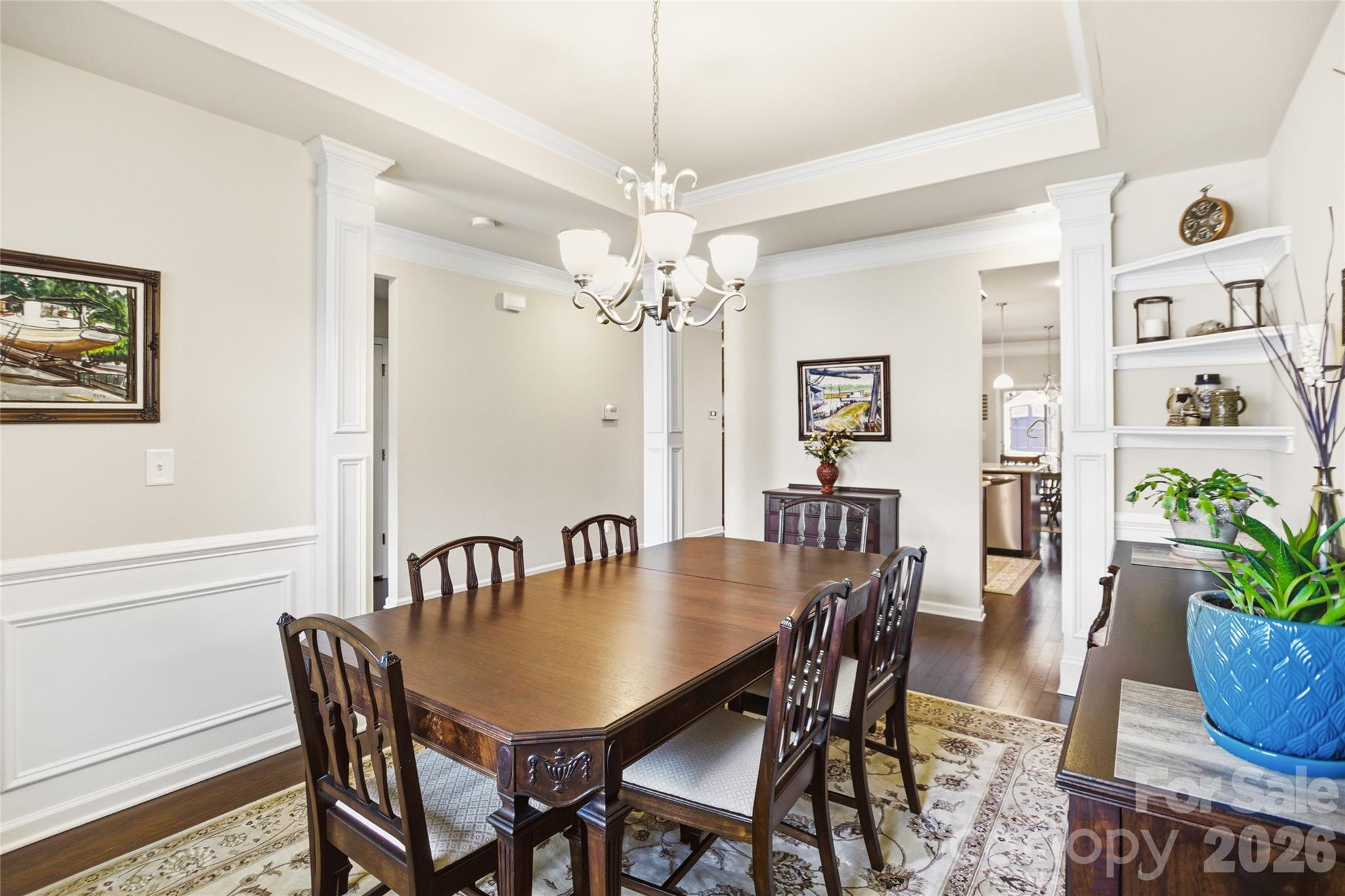 11824 Springpoint Lane Charlotte, NC 28278 - Photo 3 of 26 a dining room with furniture potted plants and wooden floor