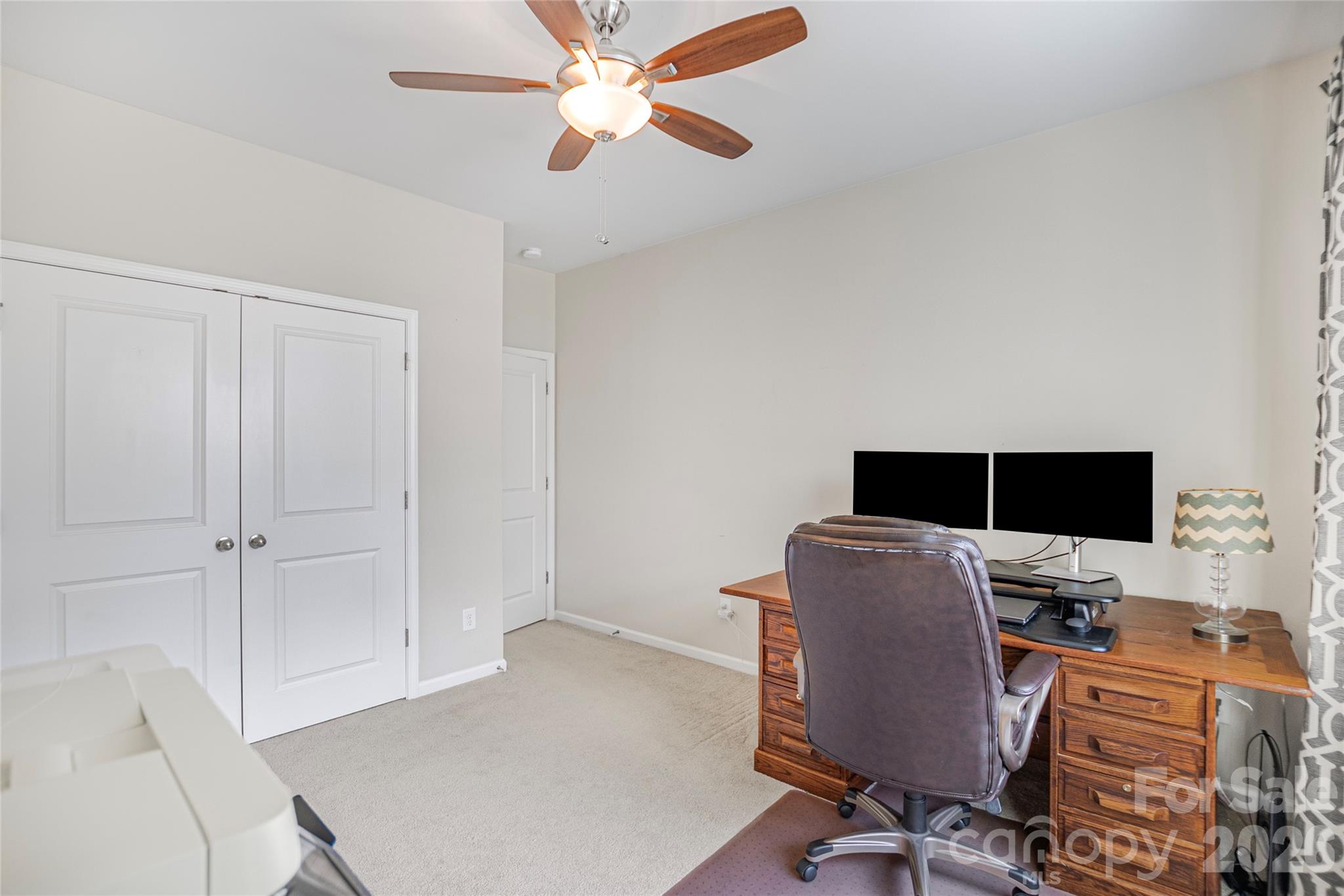 11824 Springpoint Lane Charlotte, NC 28278 - Photo 5 of 26 a view of a workspace with furniture and a ceiling fan