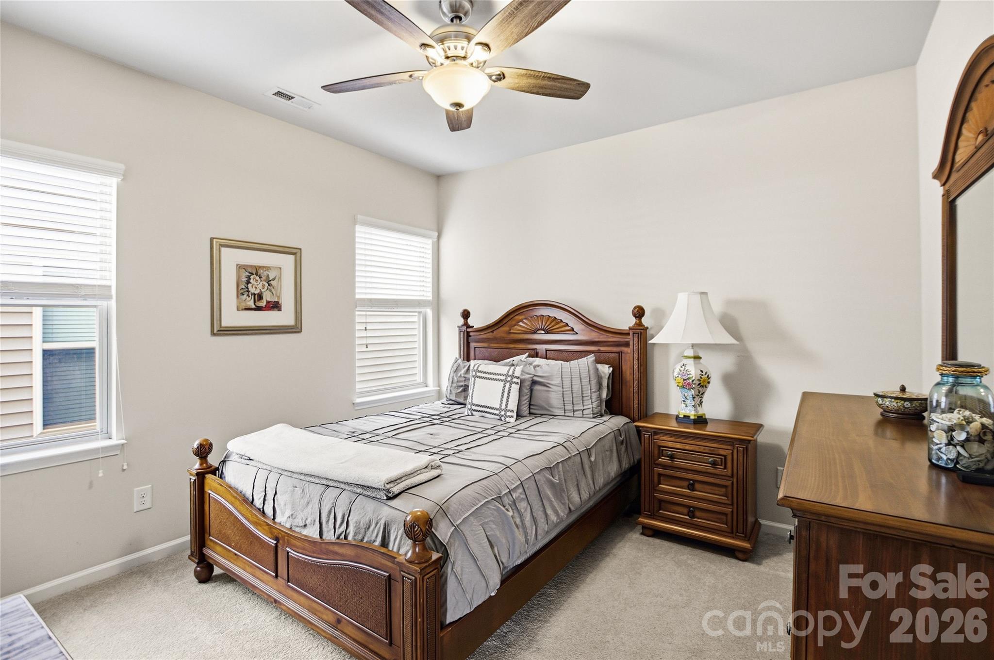 11824 Springpoint Lane Charlotte, NC 28278 - Photo 6 of 26 a bedroom with a bed a chandelier and dresser