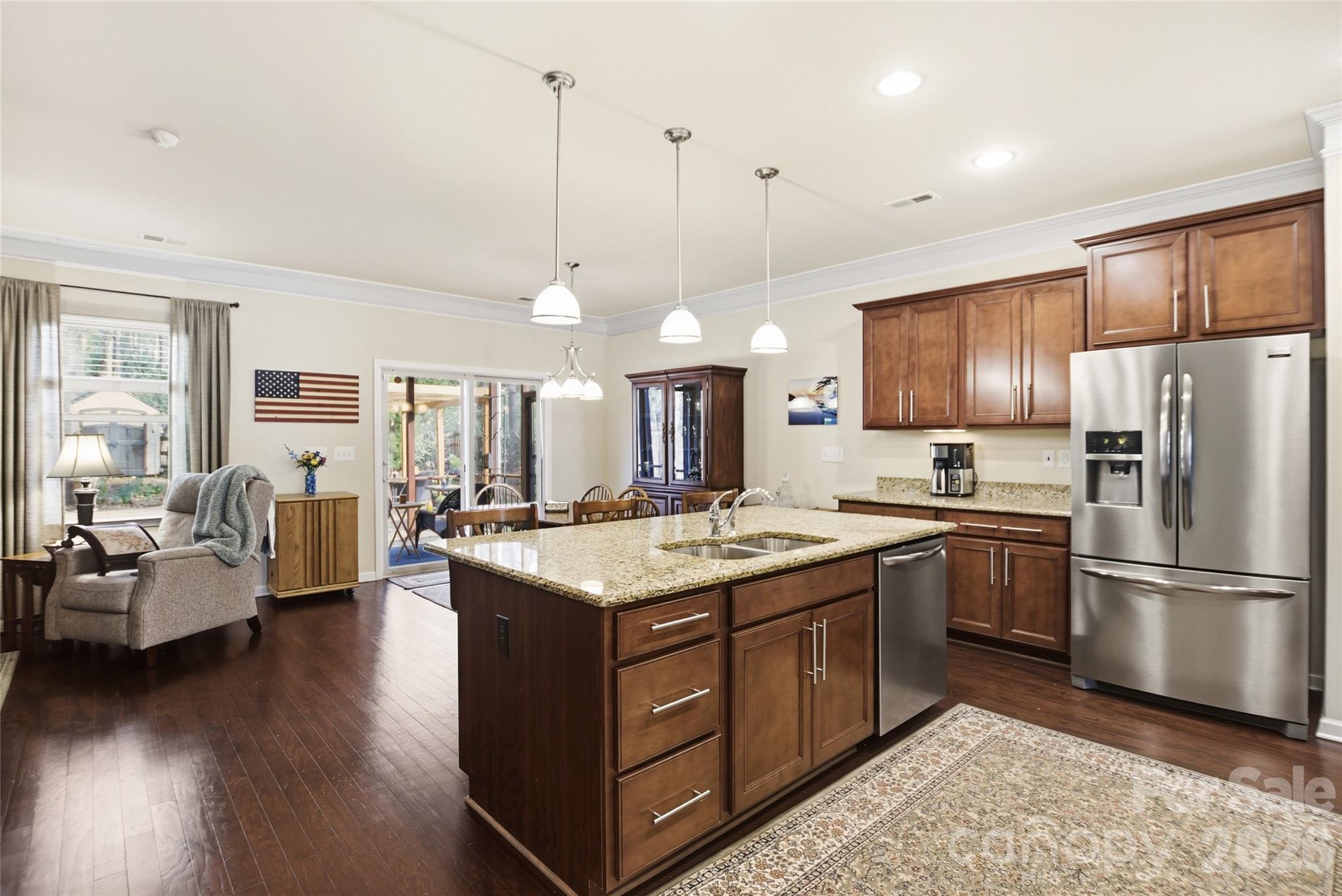 11824 Springpoint Lane Charlotte, NC 28278 - Photo 8 of 26 a kitchen with stainless steel appliances granite countertop a stove a sink dishwasher a refrigerator and a dining table with wooden floor