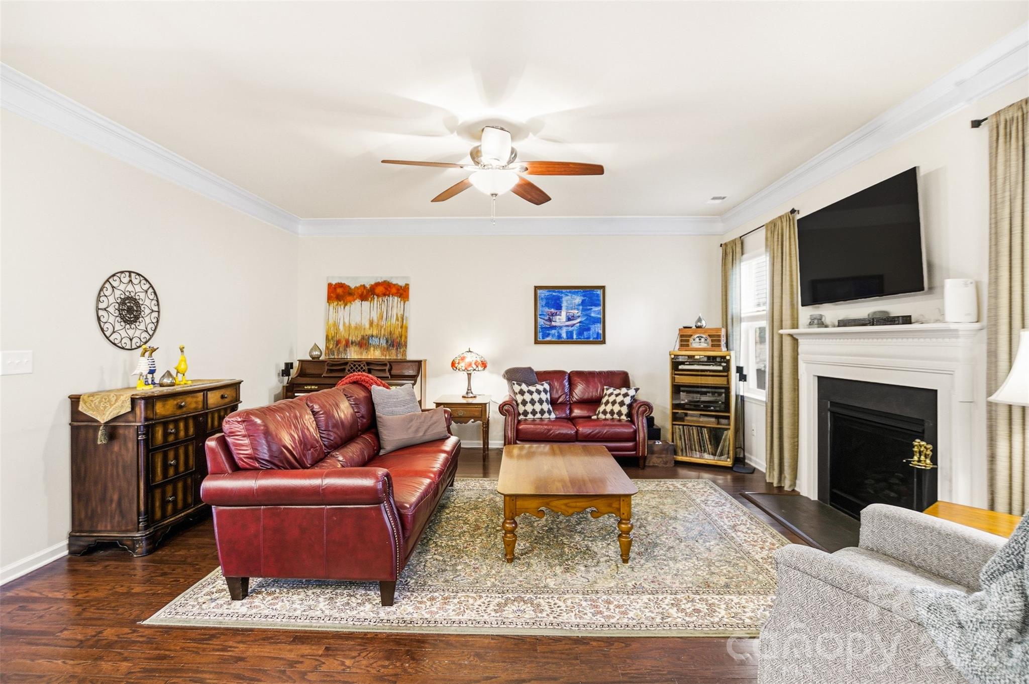 11824 Springpoint Lane Charlotte, NC 28278 - Photo 10 of 26 a living room with furniture a rug and a fireplace