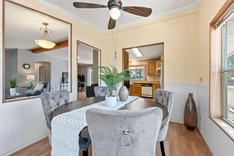 a dining room with furniture and wooden floor