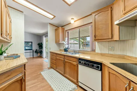 a kitchen with stainless steel appliances granite countertop a sink stove and cabinets