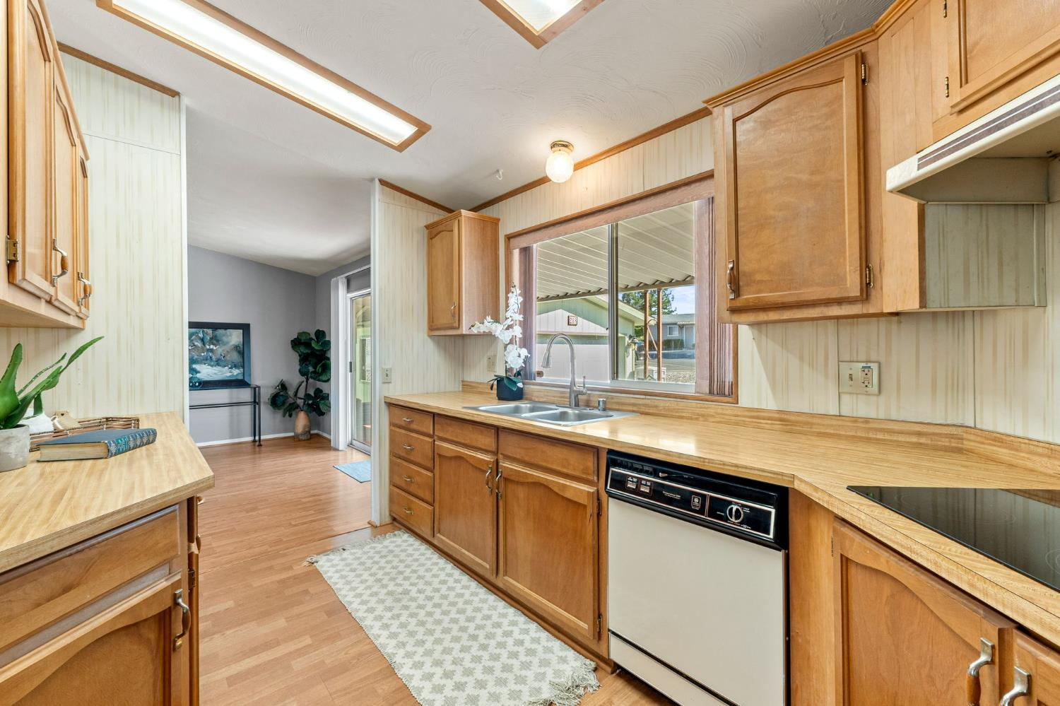 4390 Patterson Drive, Unit 218 Diamond Springs, CA 95619 - Photo 13 of 45 a kitchen with stainless steel appliances granite countertop a sink stove and cabinets
