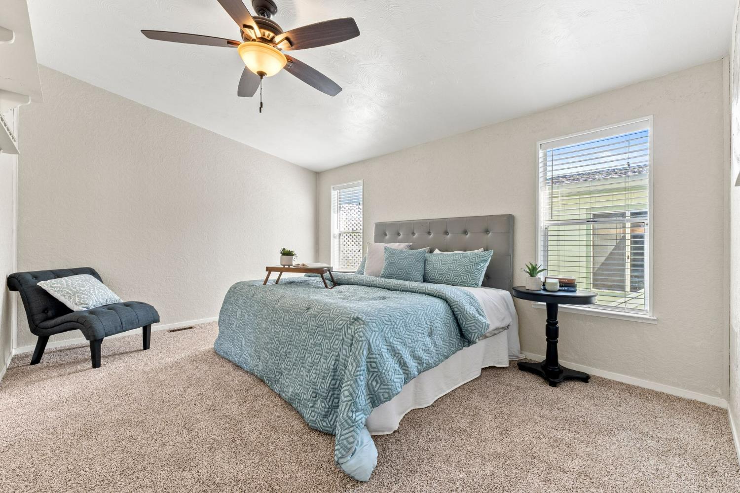 4390 Patterson Drive, Unit 218 Diamond Springs, CA 95619 - Photo 18 of 45 a spacious bedroom with a bed and a chandelier